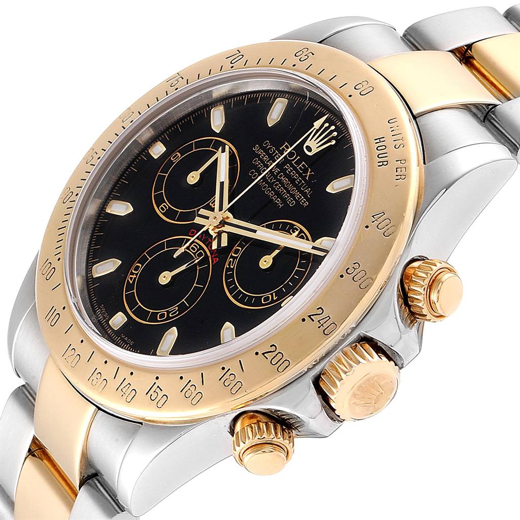 The image shows a close-up angle of the Rolex Daytona 116523 Men's Steel and Gold (two tone) Black Dial 116523 Men's Steel and Gold (two tone) Black Dial watch, highlighting the dial, bezel, and side pushers.