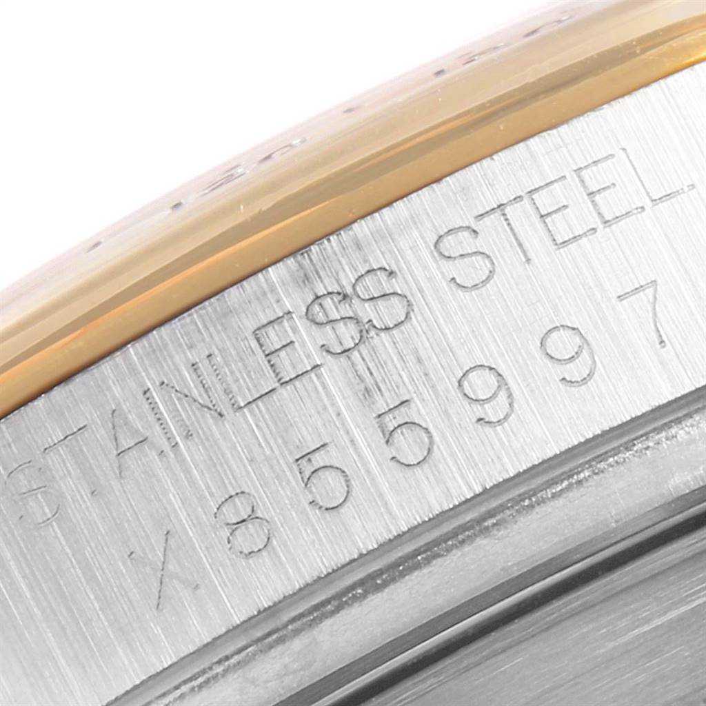 This close-up image of a Rolex Daytona 16523 Men's Steel and Gold (two tone) Champagne Dial 16523 Men's Steel and Gold (two tone) Champagne Dial watch shows the engraved "STAINLESS STEEL" text and part of the bezel.