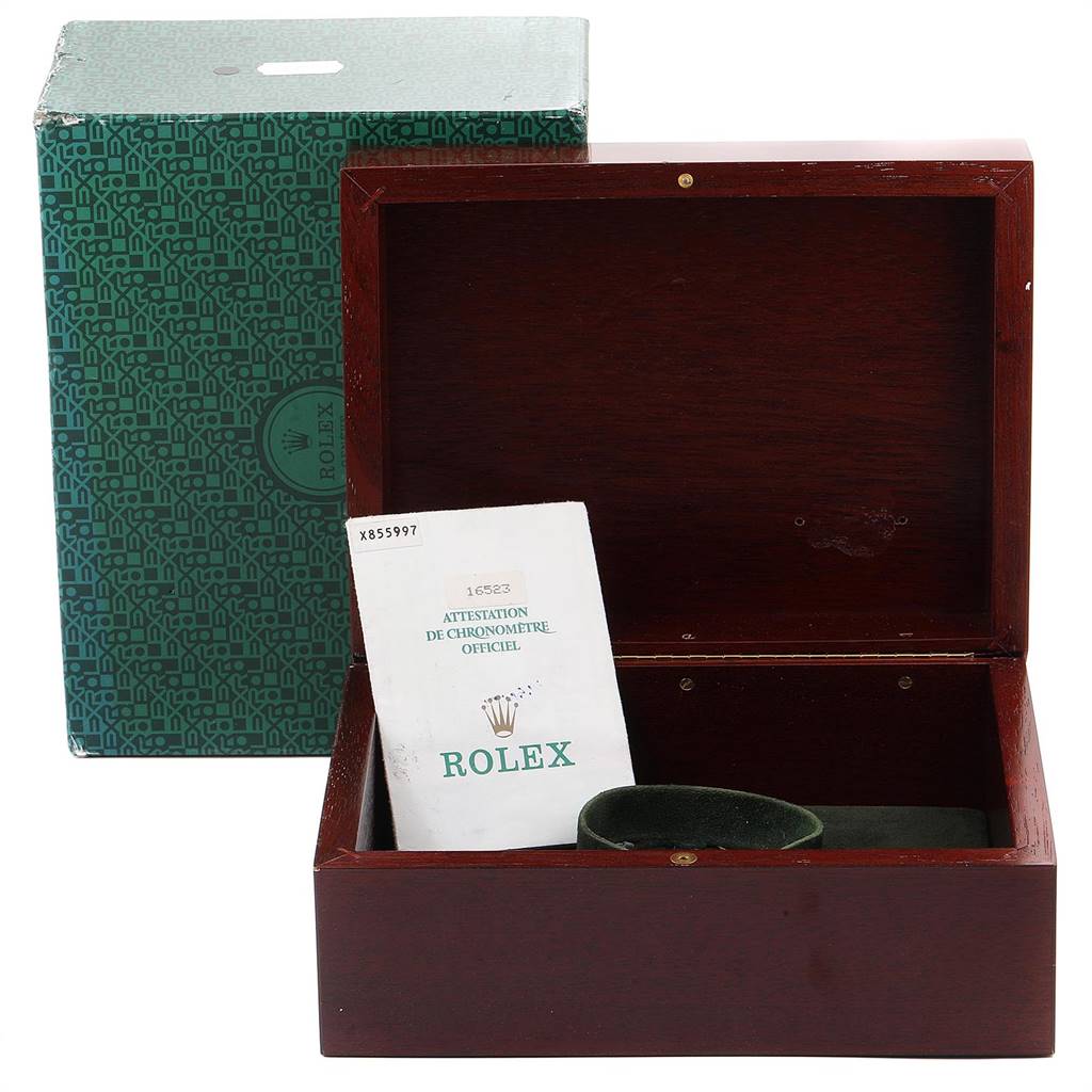 This image shows an open box and green outer box for a Rolex Daytona 16523 Men's Steel and Gold (two tone) Champagne Dial 16523 Men's Steel and Gold (two tone) Champagne Dial, including documentation.