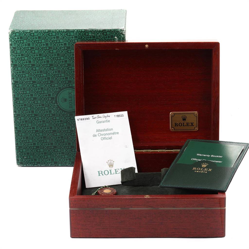 The image shows a Rolex Daytona 116523 Men
s Steel and Gold (two tone) Mother of Pearl Dial 116523 Men
s Steel and Gold (two tone) Mother of Pearl Dial box, warranty booklet, and certification papers from a slightly angled top view.