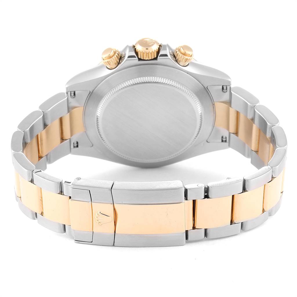 The image shows the rear view of a Rolex Daytona 116523 Men
s Steel and Gold (two tone) Mother of Pearl Dial 116523 Men
s Steel and Gold (two tone) Mother of Pearl Dial wristwatch, focusing on its clasp, case back, and bracelet.