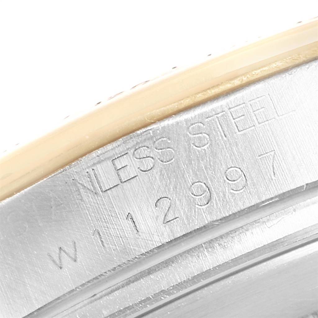 This image shows a close-up of the case back edge of a Rolex Daytona 16523 Men's Steel and Gold (two tone) White Dial 16523 Men's Steel and Gold (two tone) White Dial watch, highlighting the stainless steel marking and serial number.
