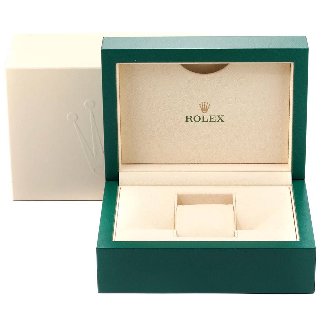 The image shows an open green Rolex watch box, likely for the Daytona model, with a cream interior and Rolex logo.