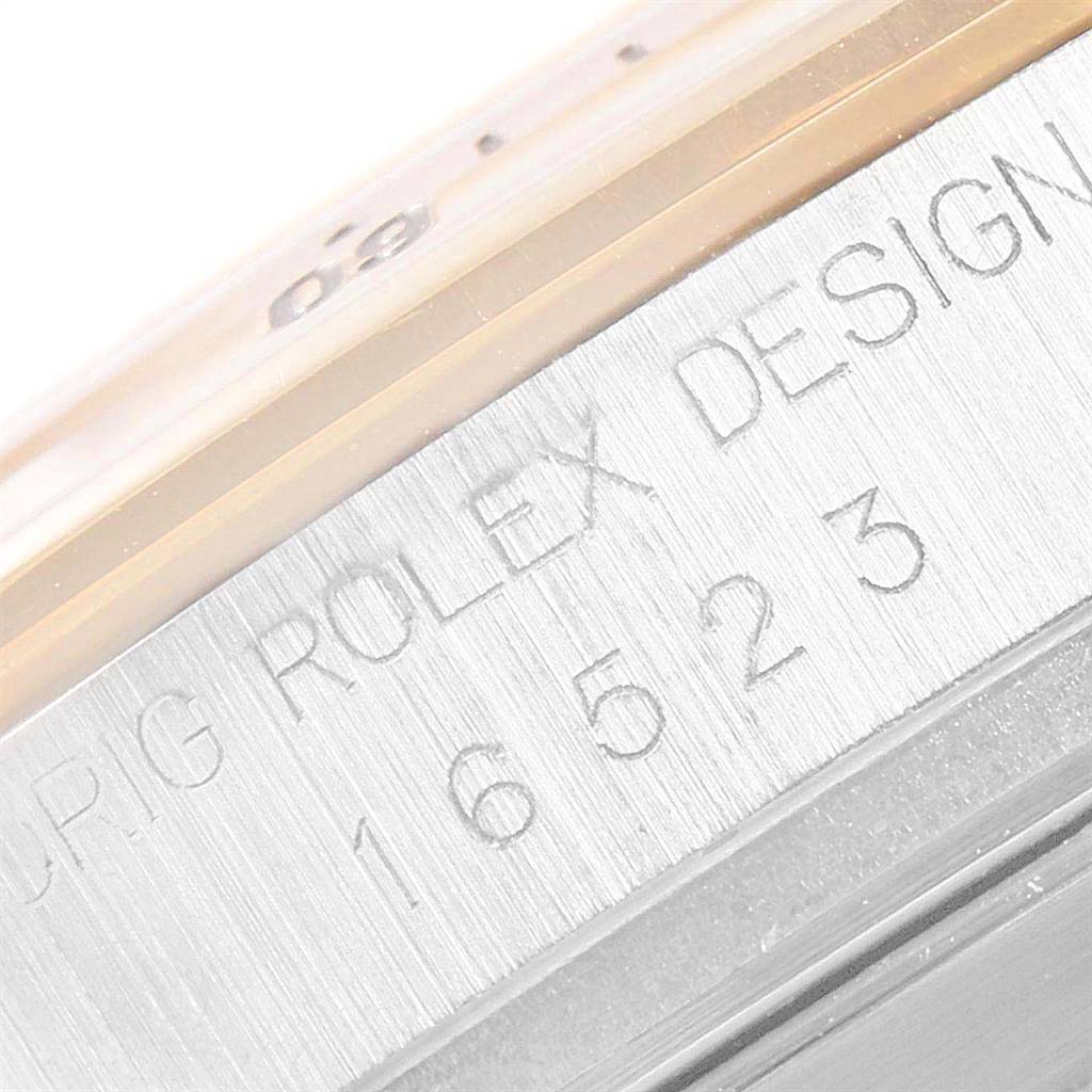 This image shows a close-up of the engraving on the side of a Rolex Daytona 16523 Men's Steel and Gold (two tone) Grey Dial 16523 Men's Steel and Gold (two tone) Grey Dial watch case.
