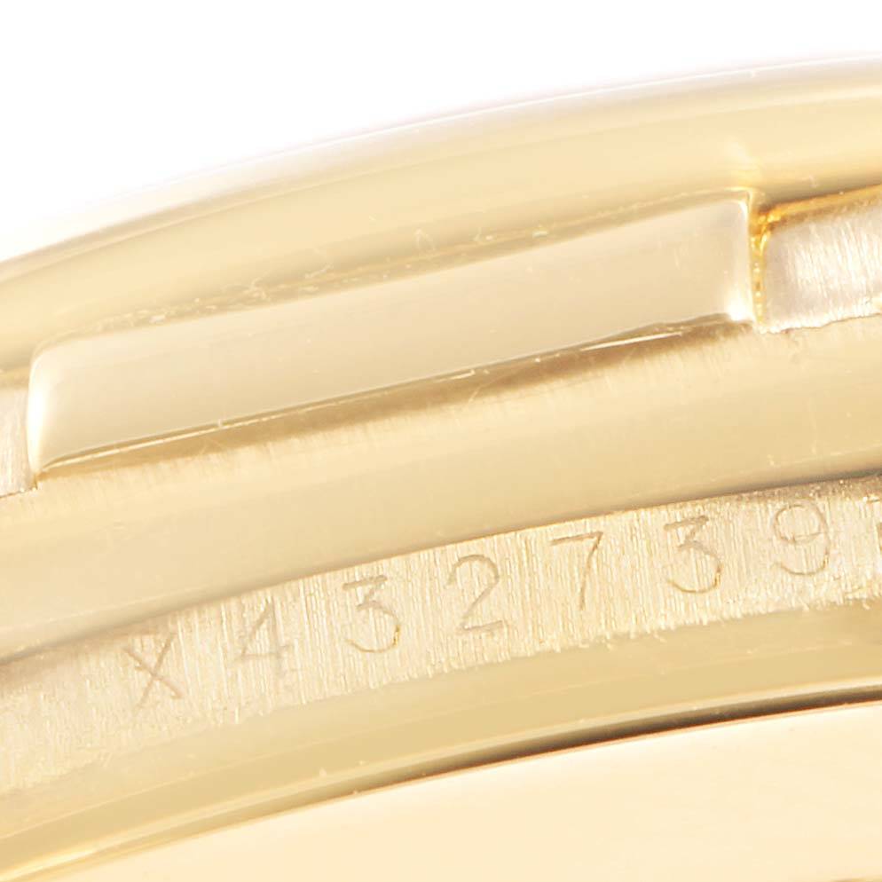 The image shows a close-up of the Rolex Daytona 16518 Men's Yellow Gold White Dial 16518 Men's Yellow Gold White Dial watch serial number engraved on its case.