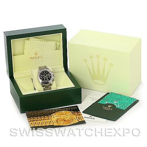 This image shows a Rolex Daytona 116520 Men's Stainless Steel Black Dial 116520 Men's Stainless Steel Black Dial watch from the front, along with its open box, warranty card, cleaning cloth, and instruction manuals.
