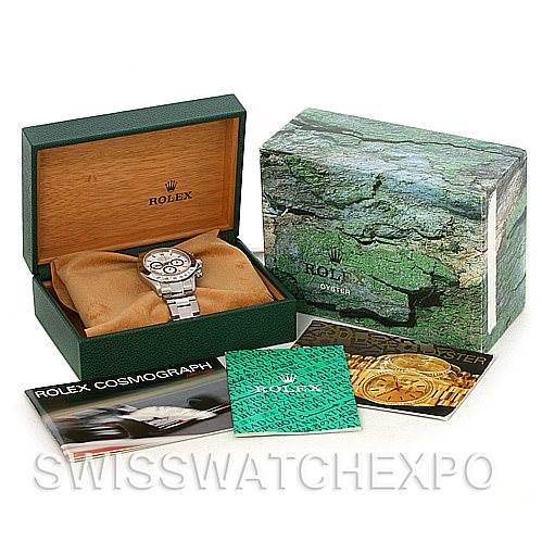 The image shows a Rolex Daytona 16520 Men's Stainless Steel White Dial 16520 Men's Stainless Steel White Dial watch placed in an open Rolex box with additional booklets and an outer box nearby.