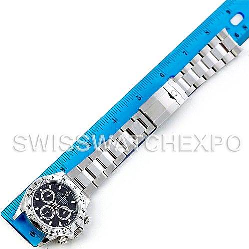 The image shows a Rolex Daytona 116520 Men's Stainless Steel Black Dial 116520 Men's Stainless Steel Black Dial watch placed next to a ruler, displaying the face and full bracelet in a flat, top-down angle.