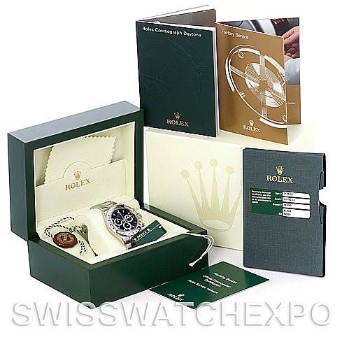 The image shows a Rolex Daytona 116520 Men's Stainless Steel Black Dial 116520 Men's Stainless Steel Black Dial watch with its accessories, including the box, warranty card, and manuals, viewed from a front angle.