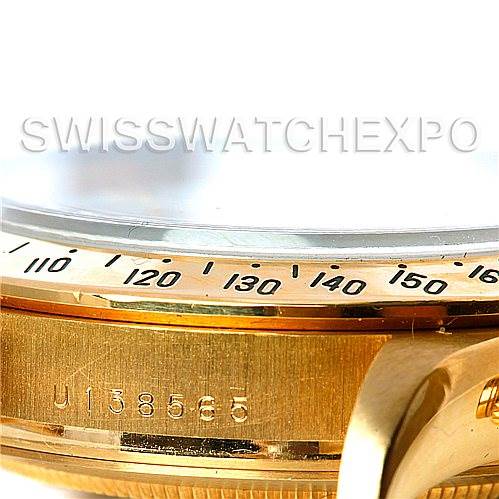 The image shows a close-up, angled view of the bezel and case side of a Rolex Daytona 16528 Men's Yellow Gold White Dial 16528 Men's Yellow Gold White Dial watch, highlighting the serial number.
