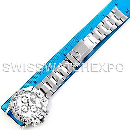 The Rolex Daytona 116520 Men's Stainless Steel White Dial 116520 Men's Stainless Steel White Dial watch is shown flat, with the full face, bracelet, and clasp visible next to a measuring ruler.