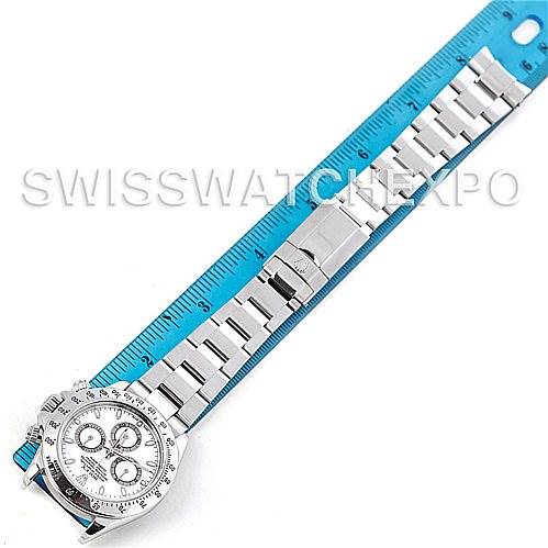 This image shows the full length of a Rolex Daytona 116520 Men's Stainless Steel White Dial 116520 Men's Stainless Steel White Dial watch, including its face, bezel, and band, alongside a blue measuring scale.