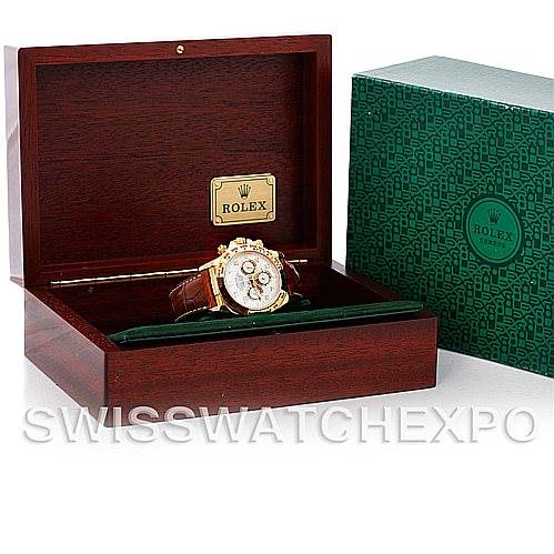 The image shows a Rolex Daytona 16518 Men's Yellow Gold White Dial 16518 Men's Yellow Gold White Dial watch angled within an open wooden box, next to its green Rolex packaging.