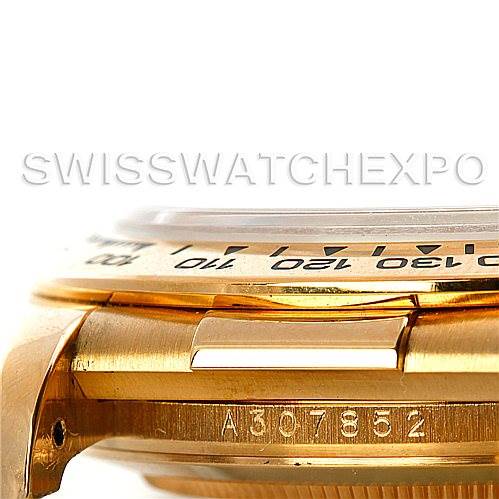 Close-up image of the side of a Rolex Daytona 16518 Men's Yellow Gold White Dial 16518 Men's Yellow Gold White Dial watch showing part of the bezel, case, and serial number.