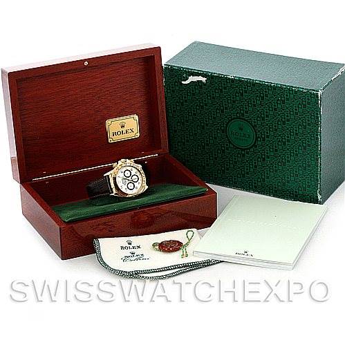 The image displays a Rolex Daytona 16518 Men's Yellow Gold White Dial 16518 Men's Yellow Gold White Dial watch in an open wooden box, accompanied by its original green packaging, manual, and accessories.