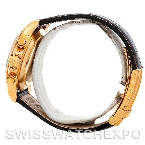 The image shows a side angle of a Rolex Daytona 16518 Men's Yellow Gold White Dial 16518 Men's Yellow Gold White Dial watch, displaying the crown, pushers, and part of the leather strap.