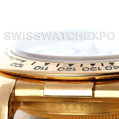 The close-up side angle of the Rolex Daytona 16518 Men's Yellow Gold White Dial 16518 Men's Yellow Gold White Dial watch shows the bezel with engraved numbers and part of the case.