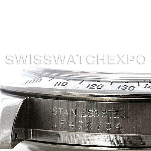 This close-up image of the Rolex Daytona 116520 Men's Stainless Steel White Dial 116520 Men's Stainless Steel White Dial watch shows the side view with the stainless steel label and part of the bezel.