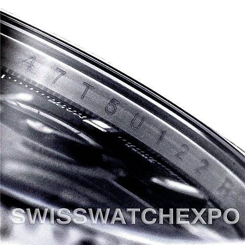 The image shows a close-up angle of the engraved serial number on the bezel of a Rolex Daytona 116520 Men's Stainless Steel Black Dial 116520 Men's Stainless Steel Black Dial watch.