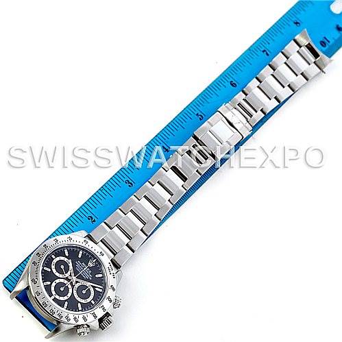 The image shows the full length of the Rolex Daytona 16520 Men's Stainless Steel Black Dial 16520 Men's Stainless Steel Black Dial watch, including the dial, bracelet, and clasp, next to a ruler for scale.