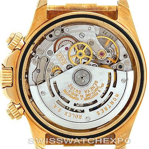 The image shows the back view of a Rolex Daytona 16518 Men's Yellow Gold White Dial 16518 Men's Yellow Gold White Dial watch, displaying its intricate inner movement and mechanical parts.