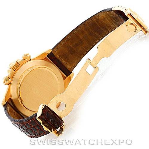 This image shows the back case, crown, and deployment clasp of a Rolex Daytona 16518 Men's Yellow Gold White Dial 16518 Men's Yellow Gold White Dial watch with a leather strap, viewed from the side.
