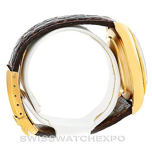 This image shows a side view of a Rolex Daytona 16518 Men's Yellow Gold White Dial 16518 Men's Yellow Gold White Dial watch with a brown leather strap and gold case.