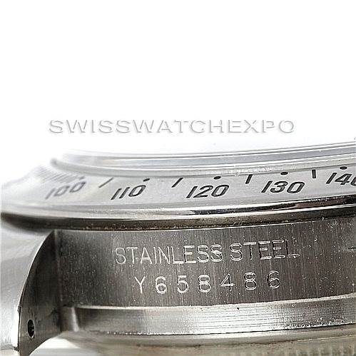 This image shows a close-up side angle of the stainless steel bezel and case of the Rolex Daytona 116520 Men's Stainless Steel Black Dial 116520 Men's Stainless Steel Black Dial watch, revealing its engraved serial number.