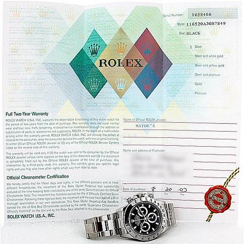 The image shows a Rolex Daytona 116520 Men's Stainless Steel Black Dial 116520 Men's Stainless Steel Black Dial watch and its warranty certificate laid flat, highlighting the watch's face and bracelet.