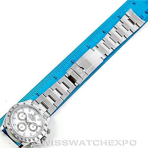 This image shows a Rolex Daytona 116520 Men's Stainless Steel White Dial 116520 Men's Stainless Steel White Dial watch laid flat next to a blue ruler, displaying the band and face from a top-down perspective.