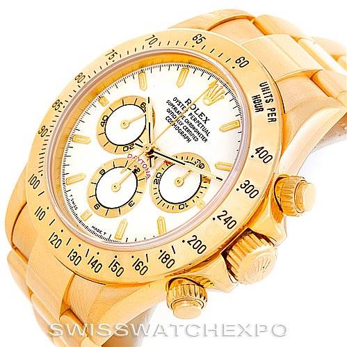 This Rolex Daytona 16528 Men's Yellow Gold White Dial 16528 Men's Yellow Gold White Dial watch is shown at an angled side view, highlighting its dial, bezel, and pushers.