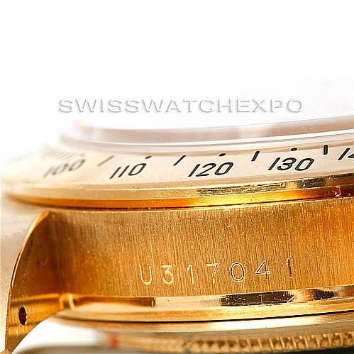 The image shows a close-up of the bezel and case side of a Rolex Daytona 16528 Men's Yellow Gold White Dial 16528 Men's Yellow Gold White Dial watch, highlighting the serial number.