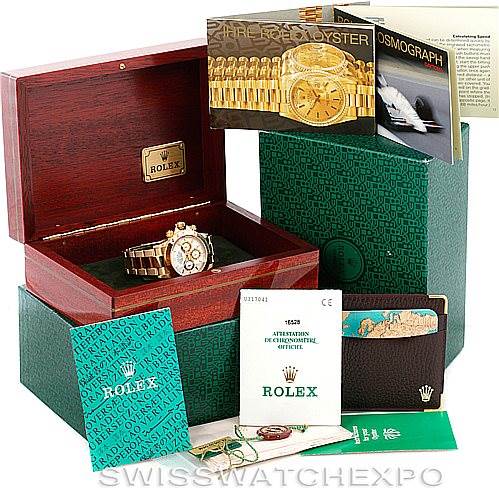 This image shows a Rolex Daytona 16528 Men's Yellow Gold White Dial 16528 Men's Yellow Gold White Dial watch in its case, accompanied by booklets, certification, and the outer packaging.