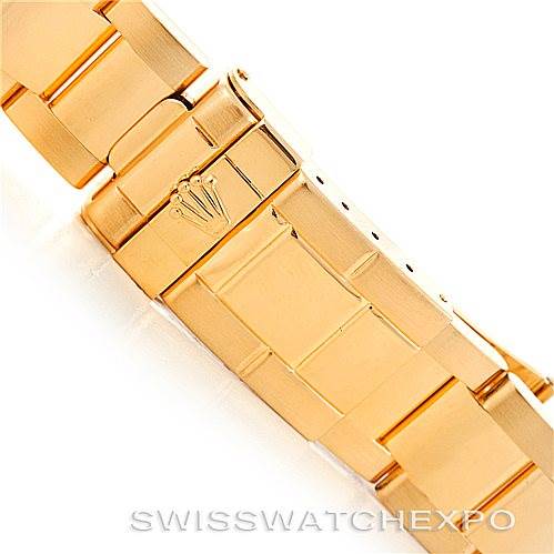 This image shows a close-up view of the clasp and bracelet of a Rolex Daytona 16528 Men's Yellow Gold White Dial 16528 Men's Yellow Gold White Dial watch, highlighting its gold finish.