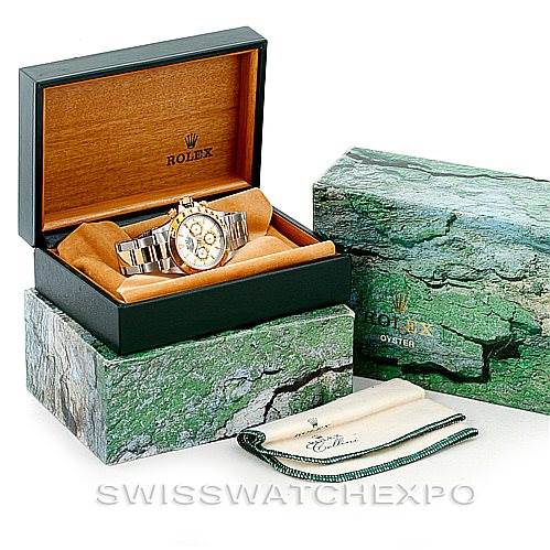 The image shows a Rolex Daytona 16523 Men's Steel and Gold (two tone) White Dial 16523 Men's Steel and Gold (two tone) White Dial model watch in its open box, along with the outer box and a branded cloth.