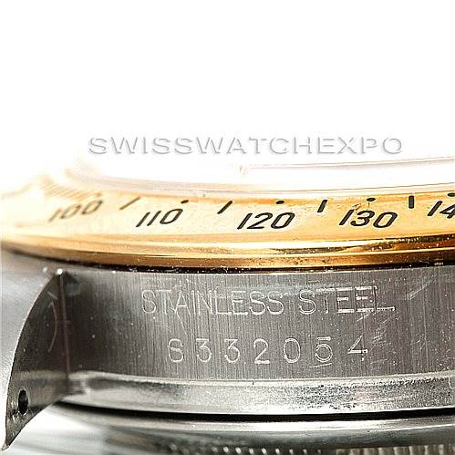 This close-up image of a Rolex Daytona 16523 Men's Steel and Gold (two tone) White Dial 16523 Men's Steel and Gold (two tone) White Dial watch shows the "STAINLESS STEEL" inscription and part of the bezel and case.