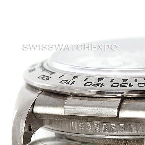 The image shows a close-up side view of a Rolex Daytona 16519 Men's White Gold White Dial 16519 Men's White Gold White Dial watch, highlighting the bezel, part of the case, and the serial number.
