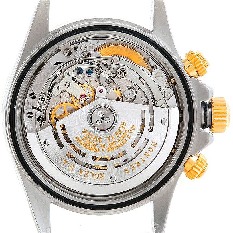 The image shows the back side of a Rolex Daytona 16523 Men's Steel and Gold (two tone) Champagne Dial 16523 Men's Steel and Gold (two tone) Champagne Dial watch, highlighting its intricate mechanical movement and components.