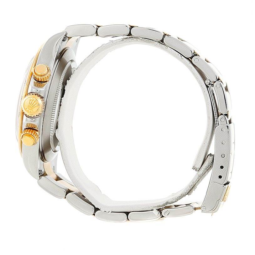 The image shows a side view of a Rolex Daytona 16523 Men's Steel and Gold (two tone) Champagne Dial 16523 Men's Steel and Gold (two tone) Champagne Dial watch, highlighting its crown, pushers, and bracelet links.