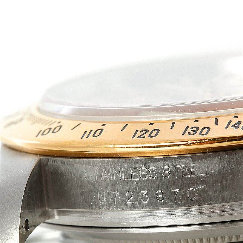 The image shows a close-up of the tachymeter bezel and part of the case with a serial number of a Rolex Daytona 16523 Men's Steel and Gold (two tone) Champagne Dial 16523 Men's Steel and Gold (two tone) Champagne Dial model.