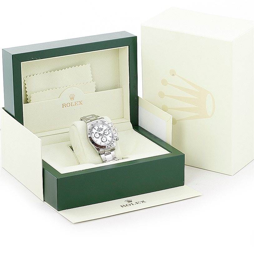 The Rolex Daytona 116520 Men's Stainless Steel White Dial 116520 Men's Stainless Steel White Dial watch is shown front-facing inside its green and cream presentation box with accompanying accessories.