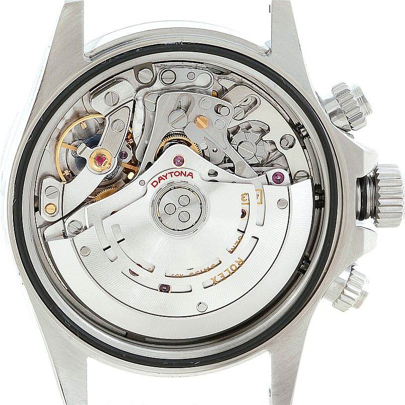 This image shows the internal mechanism of a Rolex Daytona 116520 Men's Stainless Steel White Dial 116520 Men's Stainless Steel White Dial watch from a rear view, highlighting its intricate gears and rotor.