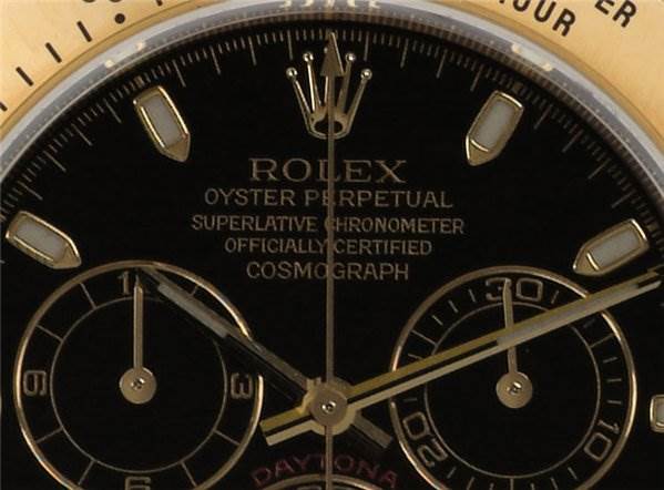 The image shows a close-up of the dial and hands of a Rolex Daytona 116523 Men's Stainless Steel Black Dial 116523 Men's Stainless Steel Black Dial watch, highlighting the brand, model name, and subdials.