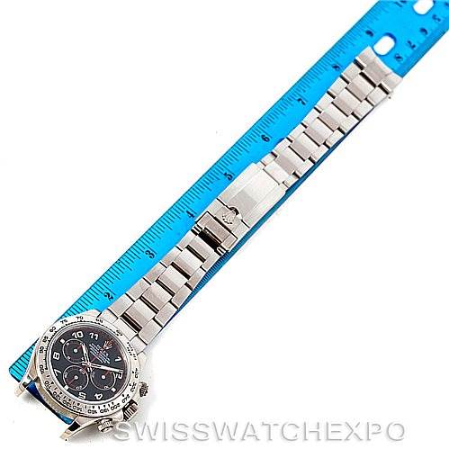 The image shows a Rolex Daytona 116509 Men's White Gold Black Dial 116509 Men's White Gold Black Dial watch laid flat next to a blue ruler, displaying the full bracelet and dial from a top-down angle.