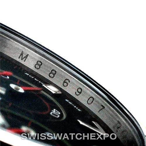 This close-up angle of the Rolex Daytona 116509 Men's White Gold Black Dial 116509 Men's White Gold Black Dial watch shows part of the bezel and serial number engraving.