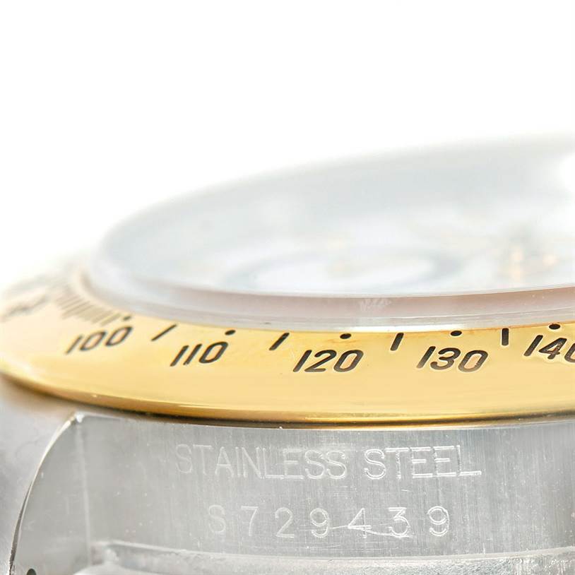 This close-up shows the stainless steel casing and gold bezel with tachymeter markings of a Rolex Daytona 16523 Men's Steel and Gold (two tone) White Dial 16523 Men's Steel and Gold (two tone) White Dial watch.