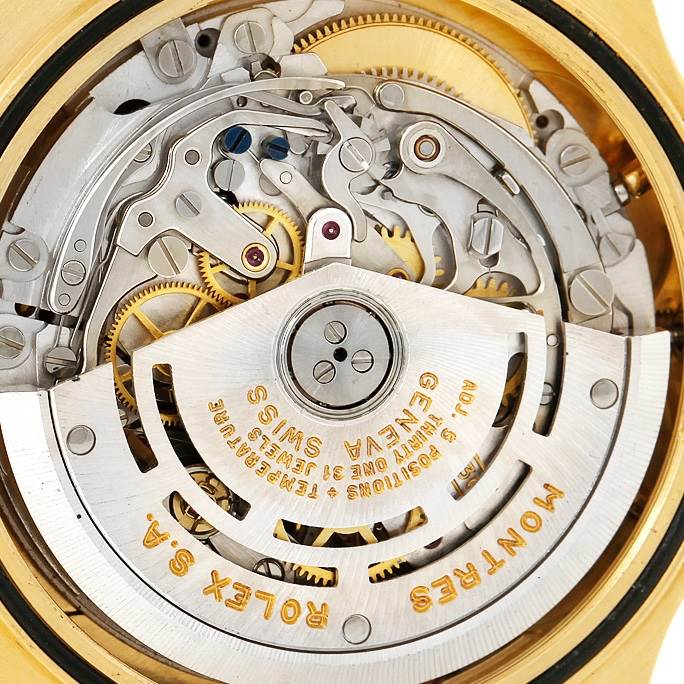The image shows a close-up view of the intricate inner mechanism of a Rolex Daytona 16518 Men's Yellow Gold White Dial 16518 Men's Yellow Gold White Dial watch, focusing on the movement and rotor.