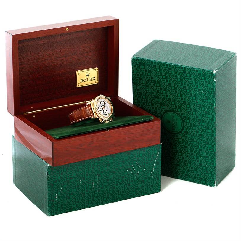 The Rolex Daytona 16518 Men's Yellow Gold White Dial 16518 Men's Yellow Gold White Dial watch is displayed inside an open wooden box with a green exterior box alongside it.