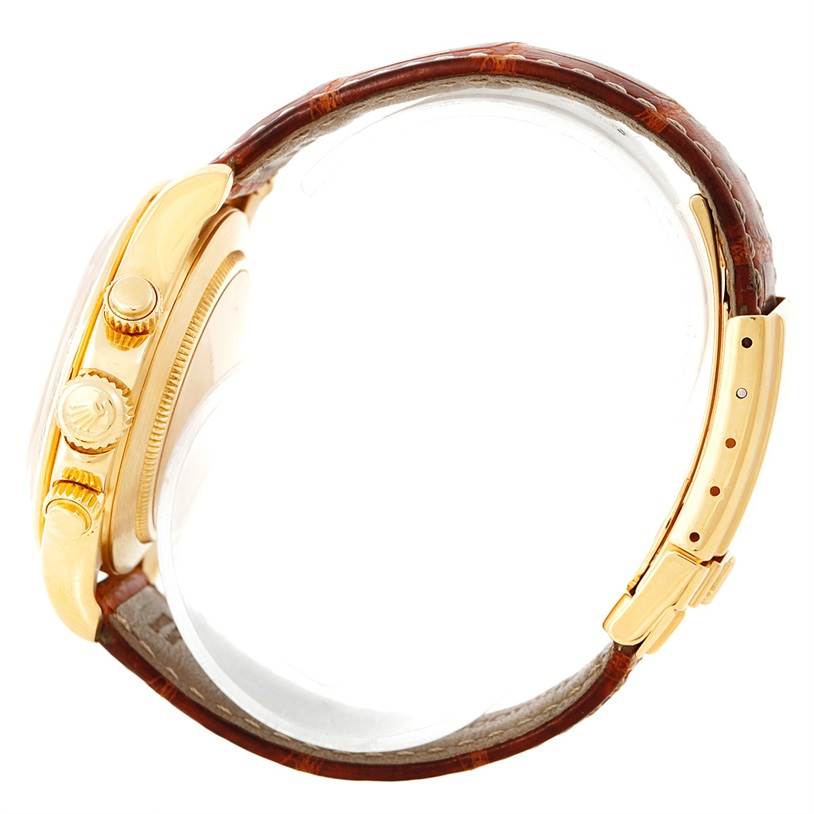 This image shows a side view of a Rolex Daytona 16518 Men's Yellow Gold White Dial 16518 Men's Yellow Gold White Dial watch, highlighting the case, crown, pushers, and leather strap with clasp.