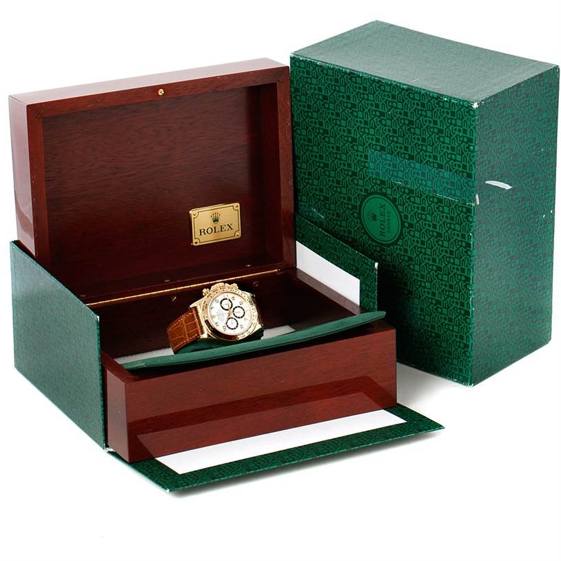 The image shows a Rolex Daytona 16518 Men's Yellow Gold White Dial 16518 Men's Yellow Gold White Dial watch in a wooden box, partially open, next to a green outer box.